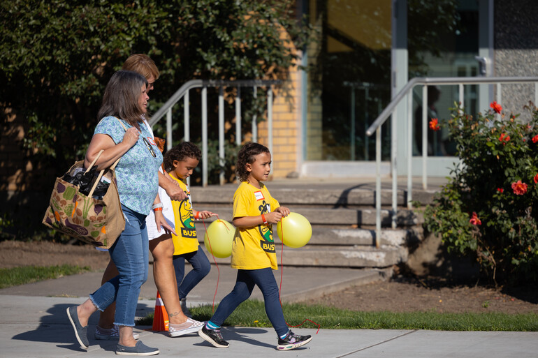Children carry balloons on WWU campus